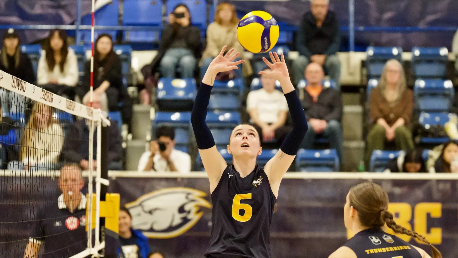 Mackenzie Campbell sets the ball up in the air while staring up at it